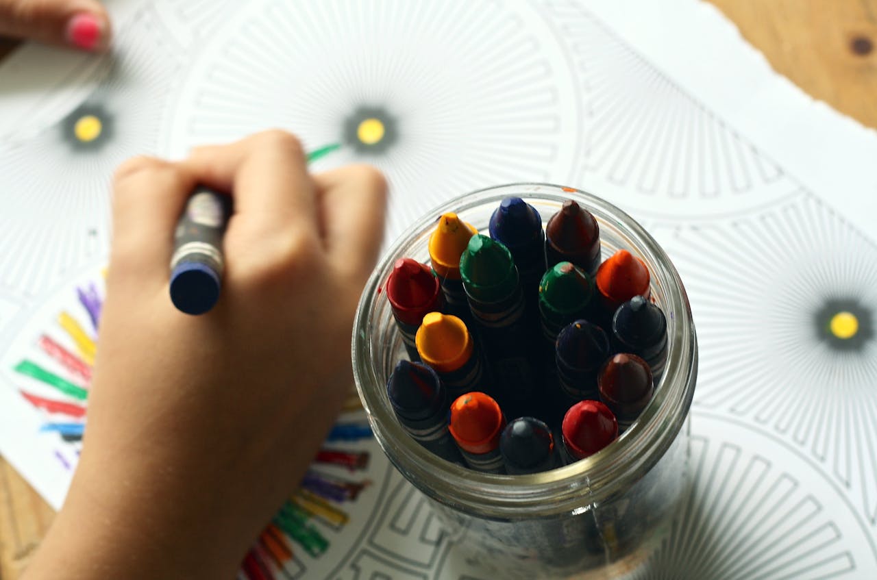 Crafting Captivating Headlines: Your awesome post title goes here A child drawing with colorful crayons, fostering creativity and fun in a learning environment.