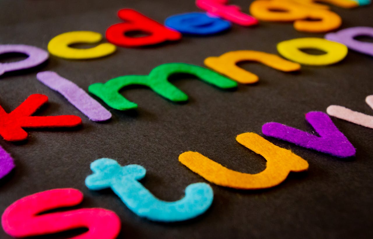 Mastering the First Impression: Your intriguing post title goes here Bright and colorful felt alphabet letters arranged on a dark surface, perfect for educational and creative projects.